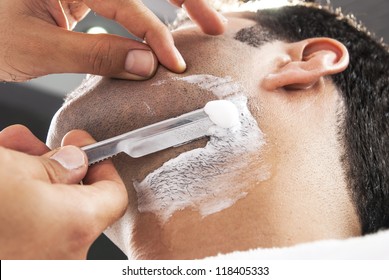 Man Having A Shave At The Barber Shop