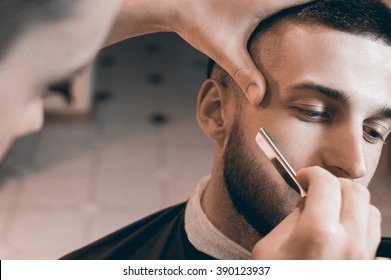 Man Having A Shave At The Barber Shop.