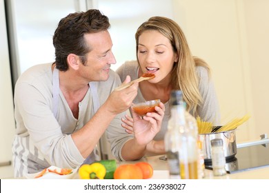 Man Having Woman Tasting Tomato Sauce