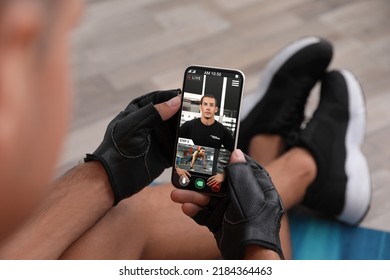 Man having workout with personal trainer via smartphone at home, closeup - Powered by Shutterstock