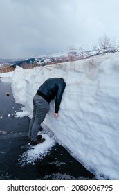 Man With Head Stuck In Snow Bank Depressed With Winter Weather.