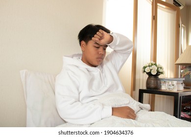 A man with a headache in bed