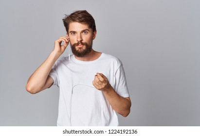 man in headphones on gray background                   - Shutterstock ID 1224192136