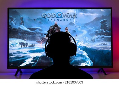 Man with headphones play God of War Ragnarok on TV screen. 20 Jul, 2022, Sao Paulo, Brazil.
