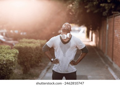 Man with headphones resting after street run - Powered by Shutterstock