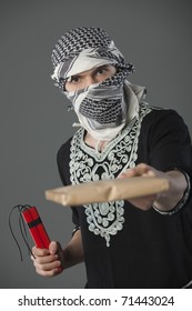 man in headscarf holding letter and dynamite