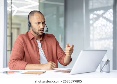 A man with a headset gestures emphatically during a video call, expressing surprise and consternation with his facial expression.