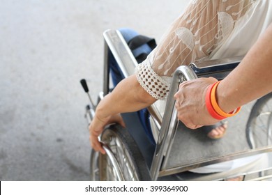 Man Helping Disabled Woman On Wheelchair In The Park