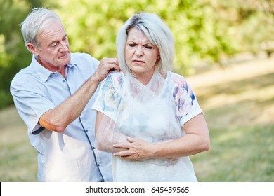 Man Helps Woman With Broken Arm With A Sling