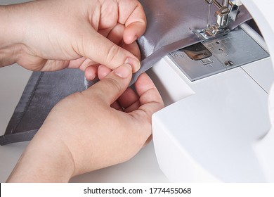 A man hem a curtain on sewing machine. Sewing, hobbies, hobby, home improvement. - Shutterstock ID 1774455068