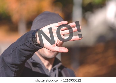 man hides his face with his hand, toned, inscription "NO!" on the hand - Shutterstock ID 1216930522