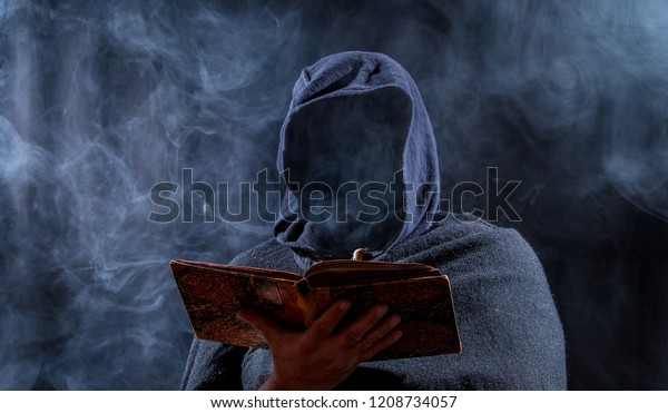 a man hides his\
face and reads in a book