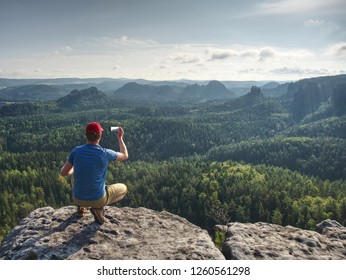 Man Hiker Enjoying The View And Taking Photos By The Phone On Mountain Ridge. 