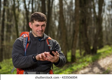 Man Hiker Taking Photo With Smart Phone In Forest