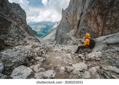Man hiker taking rest at Pass on Mountain Sassolungo - Langkofel, Alpe di Siusi, Dolomiti mountain - South Tyrol, Italy, Europe, UNESCO World Heritage Site