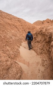 Man Hiking Among Red Rock Formations In Goblin Valley State Park In Utah.