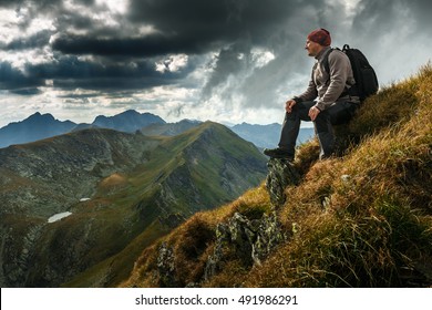 Man hiking with backpack into the mountains - Powered by Shutterstock