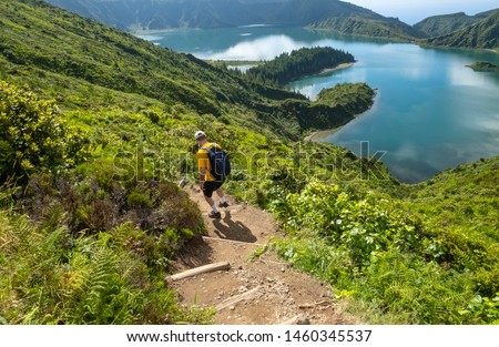 Man Hiking down to Lagoa do Fogo or Lake of Fire in Sao Miguel, Azores, Portugal