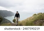 Man hiking Omanawanui track in the rain. Waitakere Ranges. Auckland. 