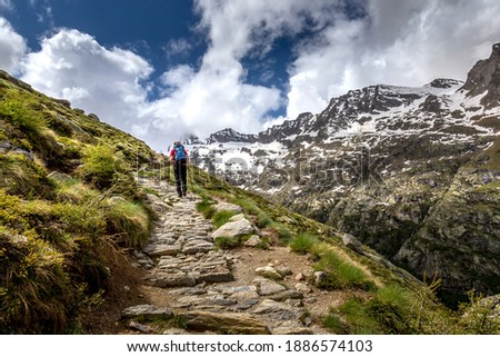 Man Hiking on a Trail to the Victor Emmanuel Refuge in the Aosta Region of Italy