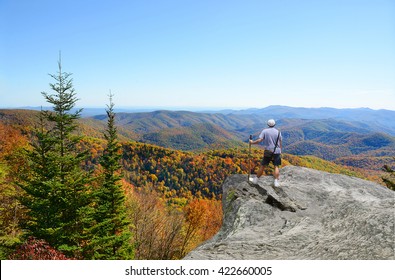 Man Hiking; Standing On Top Of The Mountain On Edge Of Cliff, Looking At Beautiful Autumn Blue Ridge Mountains Landscape. North Carolina, USA