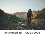 Man hiking at sunset mountains with heavy backpack Travel Lifestyle wanderlust adventure concept summer vacations outdoor alone into the wild