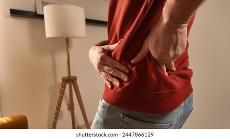 Man with hip, back and sciatica pain at home.