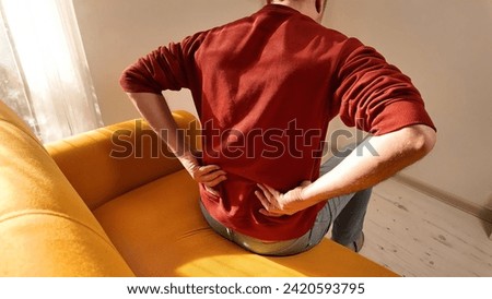 Man with hip, back and sciatica pain at home.