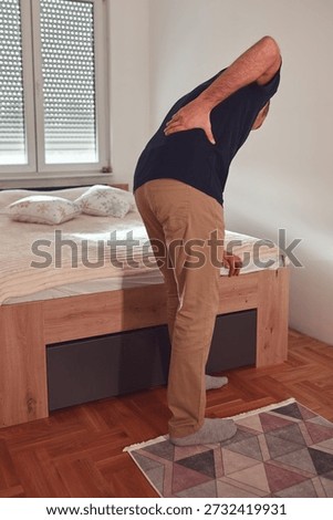 Man with hip, back, spine and sciatica pain at home.