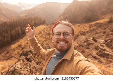 Man Hipster Traveler In Hat Making Selfie Video Vlog About Travel Mountains.