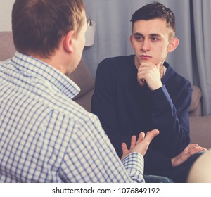 Man With His Adult Son Are Serious Talking About Life Together At The Home.