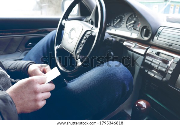 A\
man of his car of the executive class looks at the documents.\
transport, business trip and people concept - happy senior\
businessman driving car. selective focus, toning\
used