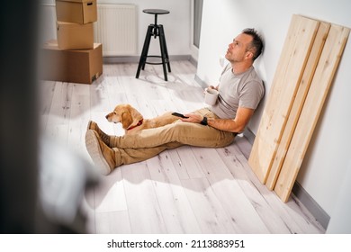 A Man With His Dog Moves Into A New Empty Apartment