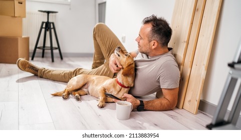 A Man With His Dog Moves Into A New Empty Apartment