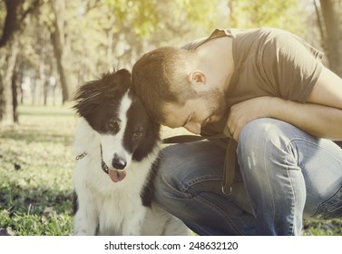 Man With His Dog Playing In The Park