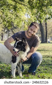 Man And His Dog Playing In The Park