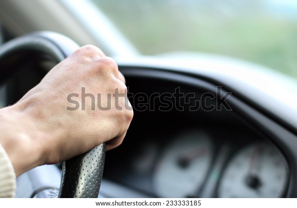 Man with his hand on the\
wheel