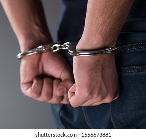 Man with his hands handcuffed in criminal concept - Shutterstock ID 1556673881