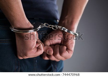 Man with his hands handcuffed in criminal concept Foto d'archivio © 