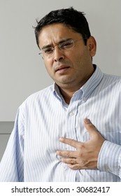 Man In His Late Thirties Having A Dose Of Heartburn Or Pains In His Chest.