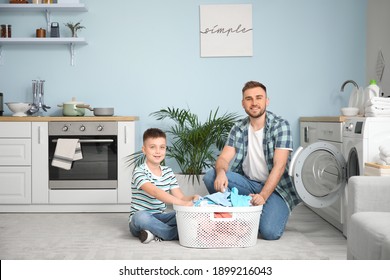 Man And His Little Son Doing Laundry At Home