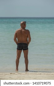 man-his-swim-shorts-beach-260nw-1410719075.jpg