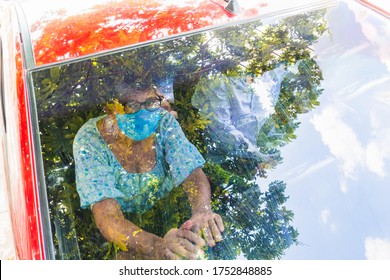 A Man With His Wife And Daughter Wearing A Protective Mask Driving. Mature Couple Driving In The Car With A Mask.