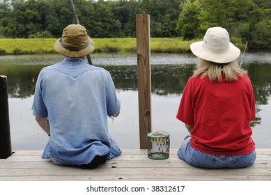 Man And His Wife Fishing On A Dock