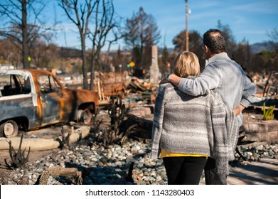 Man and his wife owners, checking burned and ruined of their house and yard after fire, consequences of fire disaster accident. Ruins after fire disaster.
