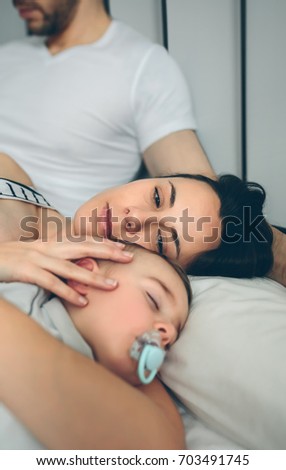 Similar – Image, Stock Photo Man with wife watching his sleeping son