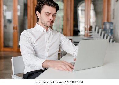 man at his workplace with laptop in the office