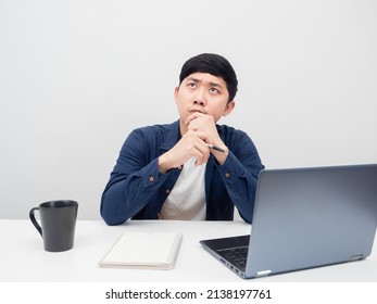 Man With His Workplace Thinking Something And Looking Up,Man With Laptop On The Desk