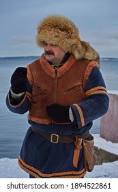 A Man In A Historical Sami Costume On The Embankment Of Lake Onega.