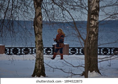 A Man In A Historical Sami Costume On The Embankment Of Lake Onega.